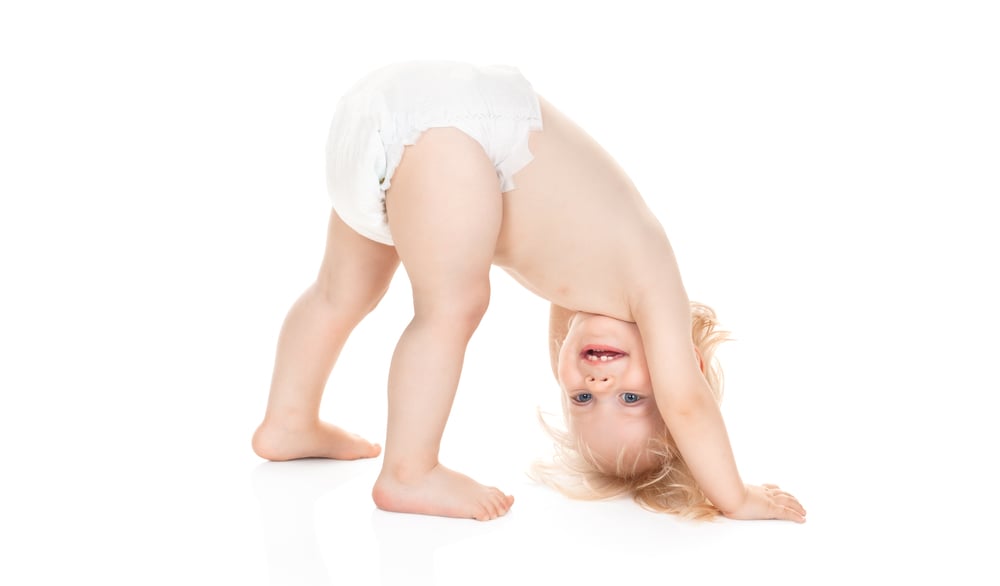 cute baby girl in diaper playing isolated on white